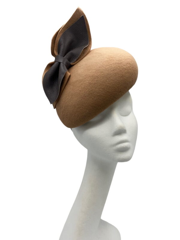 Brown/tan felt teardrop with brown leather in the bow detail.